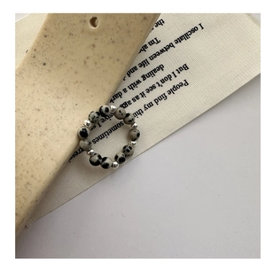 Detail view of handcrafted S925 silver beaded ring with speckled natural stone beads