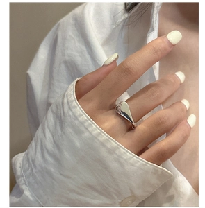 Polished S925 sterling silver heart ring worn on index finger for minimalist fashion look