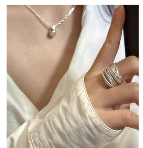 Close-up of S925 sterling silver multi-layer wrap ring on a hand with casual shirt