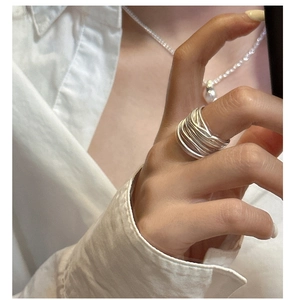 Close-up of minimalist S925 sterling silver multi-layer wrapped ring worn by a model