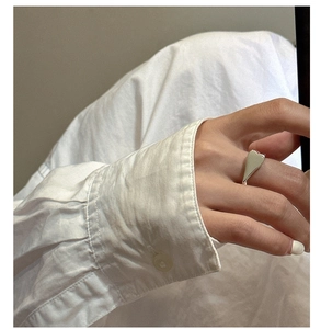 Close-up of a polished S925 sterling silver heart-shaped ring worn on a finger
