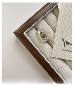 Macro shot of silver ring featuring golden tree of life relief and vintage floral engraving
