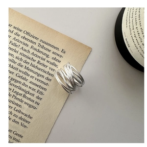 Detail of S925 sterling silver multi-layer wire wrapped ring with matte finish on book