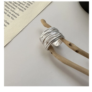 Macro shot of S925 sterling silver multi-layer wrapped ring on a natural branch