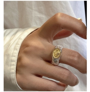 Detailed close-up of dual-tone vintage tree of life ring with baroque engraving patterns