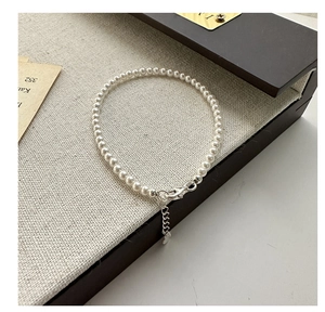 Detailed shot of 925 sterling silver pearl necklace with adjustable lobster clasp on canvas
