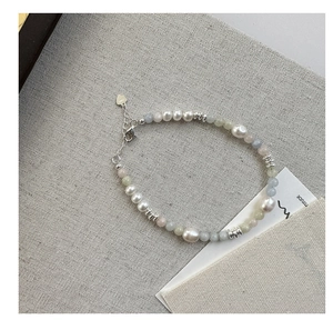 Detail of s925 silver clasp and colorful beads with pearls on a handmade bracelet