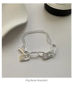 Detail of S925 sterling silver pig nose bracelet with MA MA engraving and hammered link