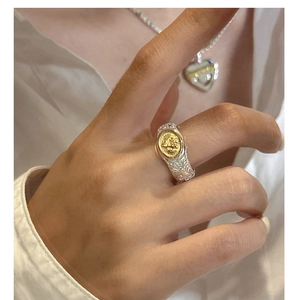 Detail of vintage S925 silver ring with tree of life pattern and gold angel emblem