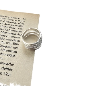 Minimalist S925 sterling silver multi-layer matte open ring on vintage paper background