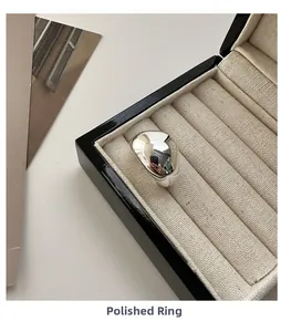 Macro detail of a polished S925 sterling silver irregular wide ring in a jewelry box