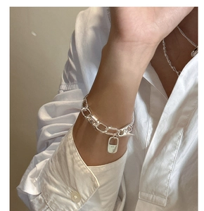 Close-up of S925 sterling silver chain bracelet with rectangular lock charm detail