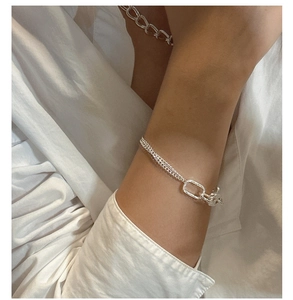 Detailed close-up of S925 silver bracelet with intricate vine pattern and lobster clasp