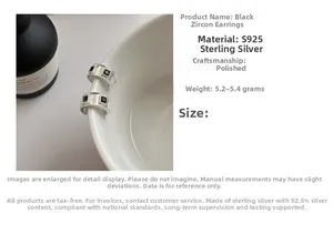 Macro shot of S925 sterling silver black zircon earrings on white porcelain bowl edge