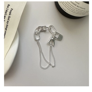 Detailed shot of S925 sterling silver chain bracelet with industrial clip and logo charm