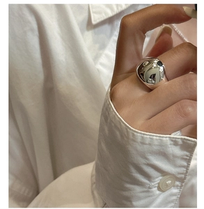 Polished S925 sterling silver wide dome ring shown on hand with minimalist style