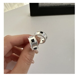 Detailed shot of wide S925 sterling silver ring with black square stones and beaded edges