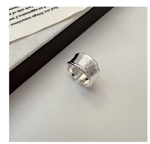Macro shot of S925 sterling silver ring featuring Dream Come True engraving and lava texture