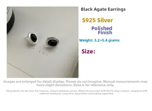 Detailed macro view of S925 sterling silver studs with oval black onyx and polished finish