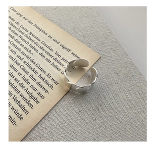 Macro detail of S925 sterling silver ring with textured flat chain link design
