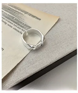 Macro detail of S925 sterling silver knotted ring with matte finish and twisted design