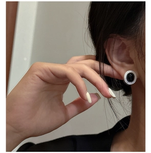Macro shot of vintage S925 silver stud earring with oval black agate and textured frame