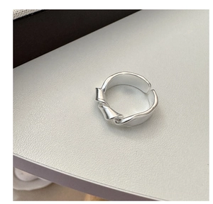 Detailed close-up of matte S925 sterling silver knotted ring with adjustable band