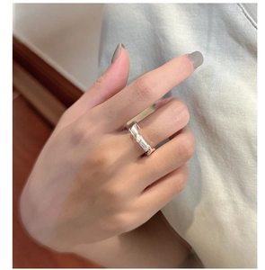 Detailed view of S925 sterling silver knotted ring on finger with a matte finish