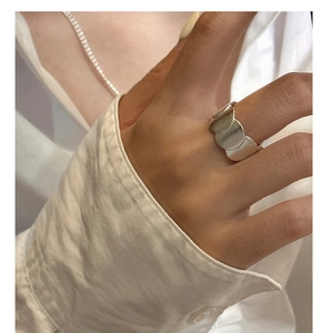 Close-up of minimalist S925 sterling silver matte geometric wide band ring on finger