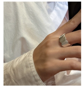 Detail of s925 sterling silver matte round ring with overlapping disc design on finger
