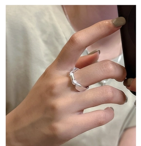 Mirror selfie showing the minimalist S925 silver knot ring on a finger with a modern style