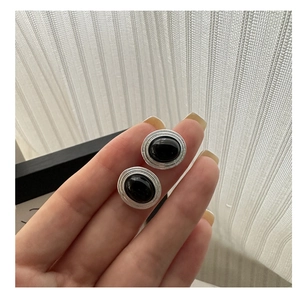 Macro shot of oval black onyx stud earrings in S925 sterling silver vintage design