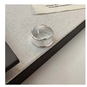 Macro detail of S925 sterling silver ring with irregular hammered texture and engraving