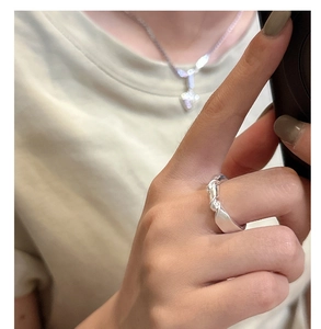 Detail of S925 sterling silver knotted ring with a matte finish on model's finger