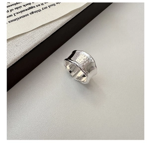 Macro view of S925 silver wide band ring featuring Dream Come True engraved letters