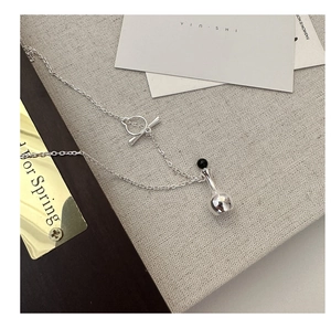 Detail of S925 silver necklace featuring a T-bar clasp and vintage perfume bottle pendant