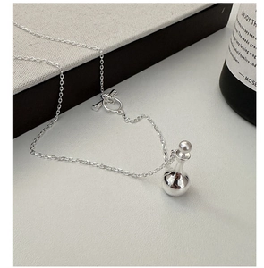 Macro detail of S925 sterling silver perfume bottle pendant with a functional OT toggle clasp