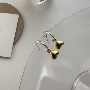Orecchini a cuore bicolore in argento S925 e oro su un bordo di vetro fine
