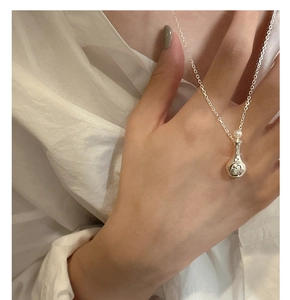 Detailed close-up of S925 sterling silver perfume bottle pendant with a small pearl