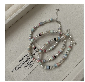 Detail of S925 sterling silver lobster clasp and colorful beaded texture on bracelets