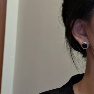 French vintage S925 silver stud earrings with round black onyx on model's ear
