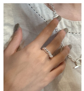 Detail of twisted rope texture S925 sterling silver ring worn on female hand