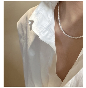 Close-up of S925 sterling silver square stone tennis necklace worn with a white shirt