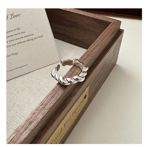 Close-up of a silver twisted croissant ring made of 925 sterling silver with open design