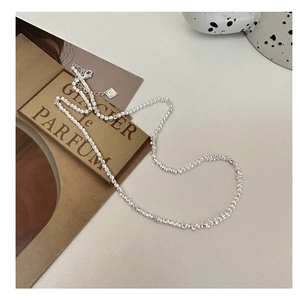 Detailed close-up of S925 sterling silver square box chain necklace on a beige backdrop