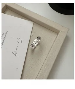 Close-up of S925 sterling silver vertical grain ring with irregular geometric sawtooth design