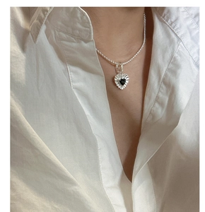 Detailed view of S925 silver necklace featuring a black heart zircon pendant on neck