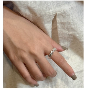 Close-up of S925 sterling silver ring with irregular vertical geometric texture on finger