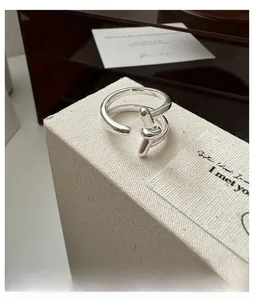 Detailed view of S925 sterling silver double-layered ring with a polished knotted design
