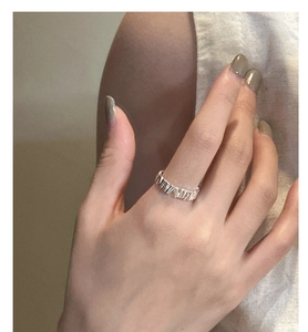 Detail of S925 silver ring featuring a unique irregular textured surface on hand